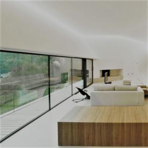 steel framed sliding door within wall of glass 