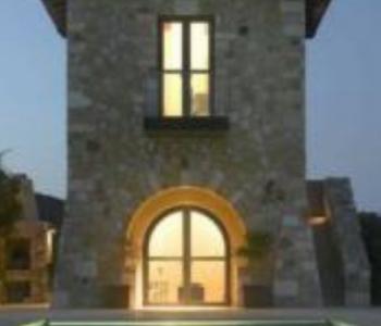 Steel framed arch doorway above a pool