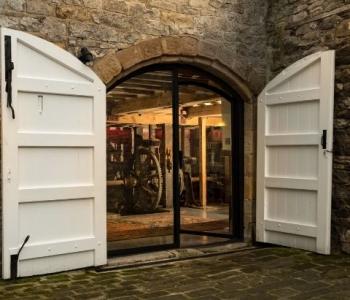 Arched steel exterior door on farm house